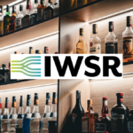 Bottles of alcohol on shelves behind a bar with IWSR logo