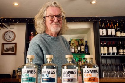 James May next to lineup of James Gin bottles