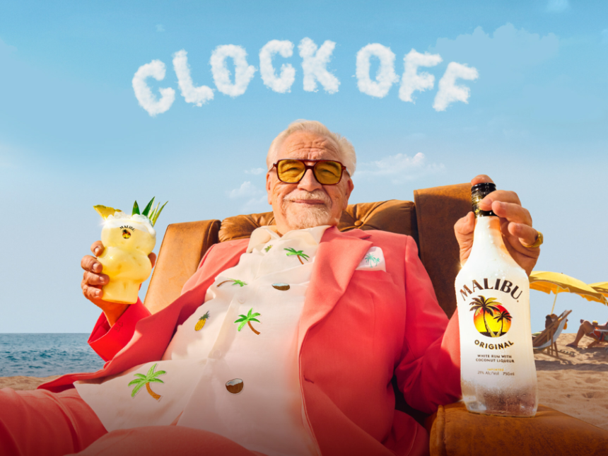 Brian Cox holding a Malibu bottle and serve with 'Clock Off' in the background