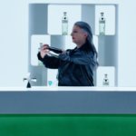 Bartender preparing cocktails with Tanqueray bottle on the bar