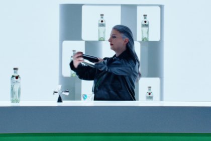 Bartender preparing cocktails with Tanqueray bottle on the bar