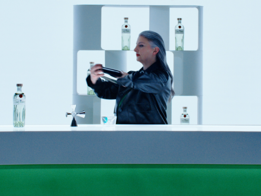 Bartender preparing cocktails with Tanqueray bottle on the bar
