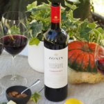 Zonin wine bottle next to three glasses