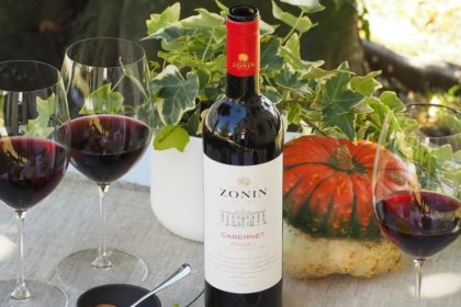 Zonin wine bottle next to three glasses