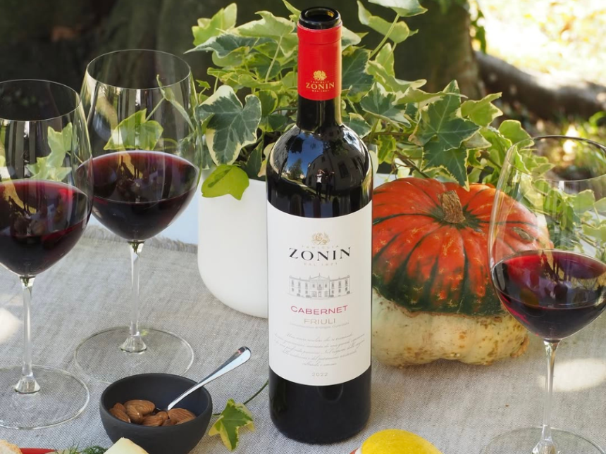 Zonin wine bottle next to three glasses