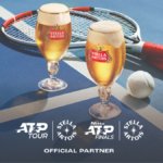 Stella Artois pint serves next to tennis rackets