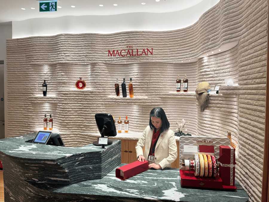 Person gift wrapping The Macallan bottle