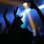 Nightclub interior dancers holdings drinks in the air
