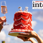 Virgin Wines cake with 25 and a raised glass of wine