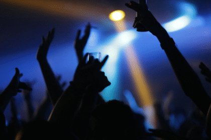 Nightclub interior dancers holdings drinks in the air