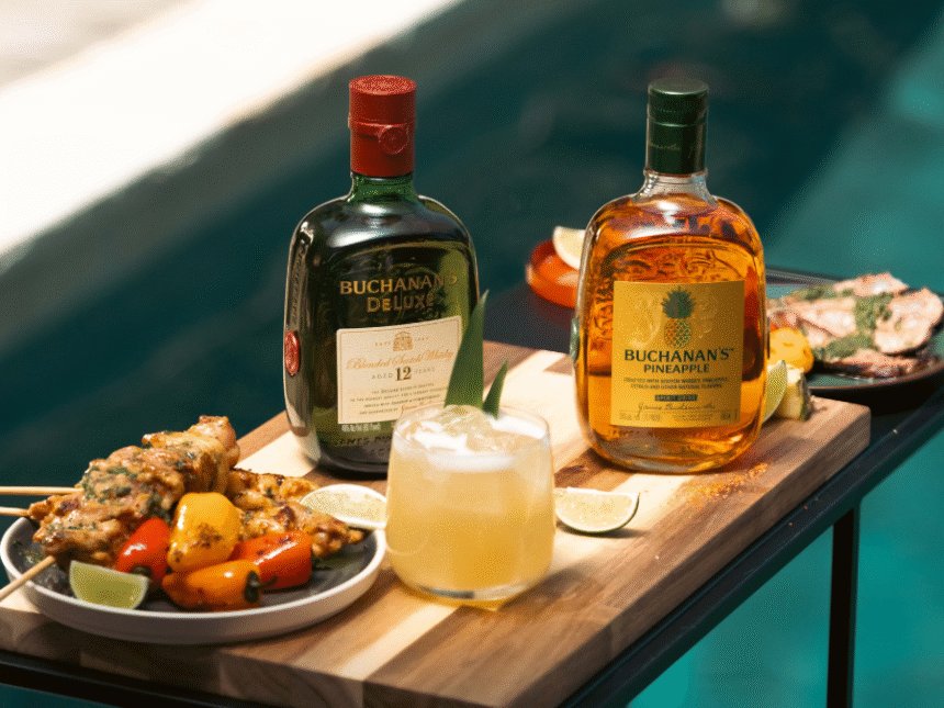 Buchanan's whisky bottles next to serves and grilled food