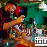 Bartender creating a cocktail at a bar