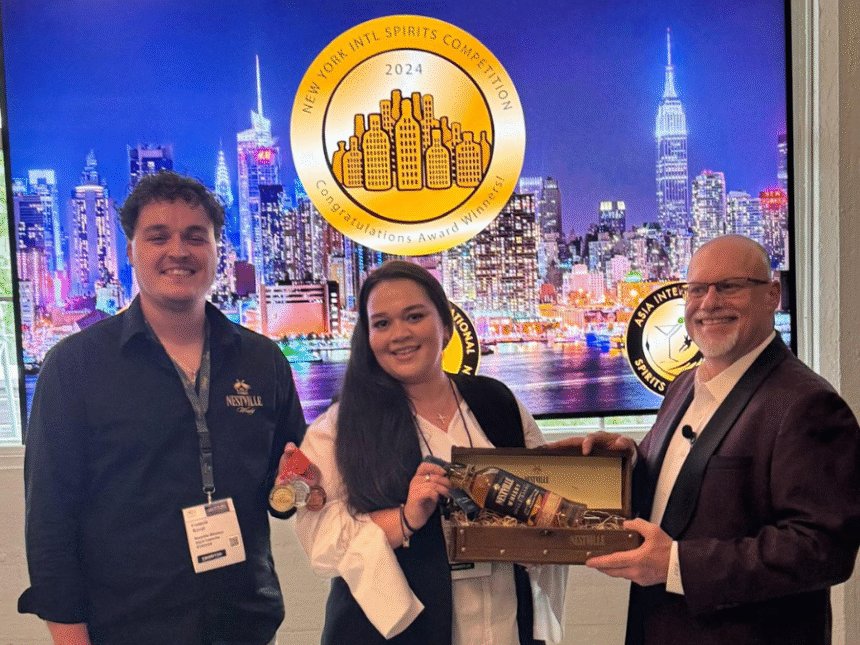 Adam Levy presents an award at the New York International Spirits Competition