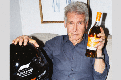 Harrison Ford with Glenmorangie bottle and F1 helmet