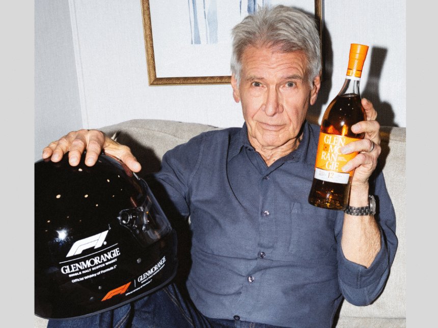 Harrison Ford with Glenmorangie bottle and F1 helmet