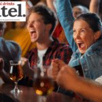 People at a bar cheering a sporting event on TV
