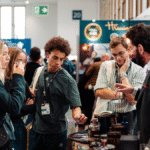 Attendees at Bar Convent Berlin around a stand
