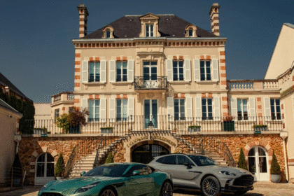Two Aston Martin's outside Bollinger champagne maison