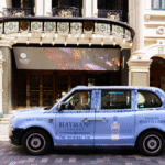 London Taxi with Hayman's Gin livery outside a theatre in the city