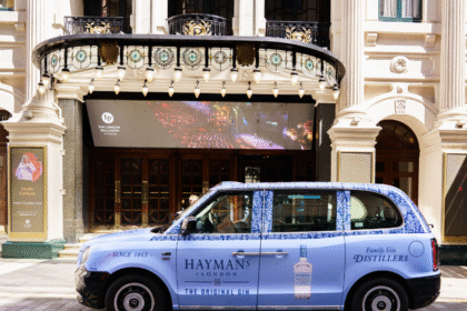 London Taxi with Hayman's Gin livery outside a theatre in the city