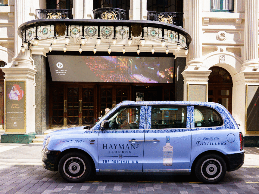 London Taxi with Hayman's Gin livery outside a theatre in the city