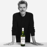 Willem Dafoe with a bottle of Laphroaig