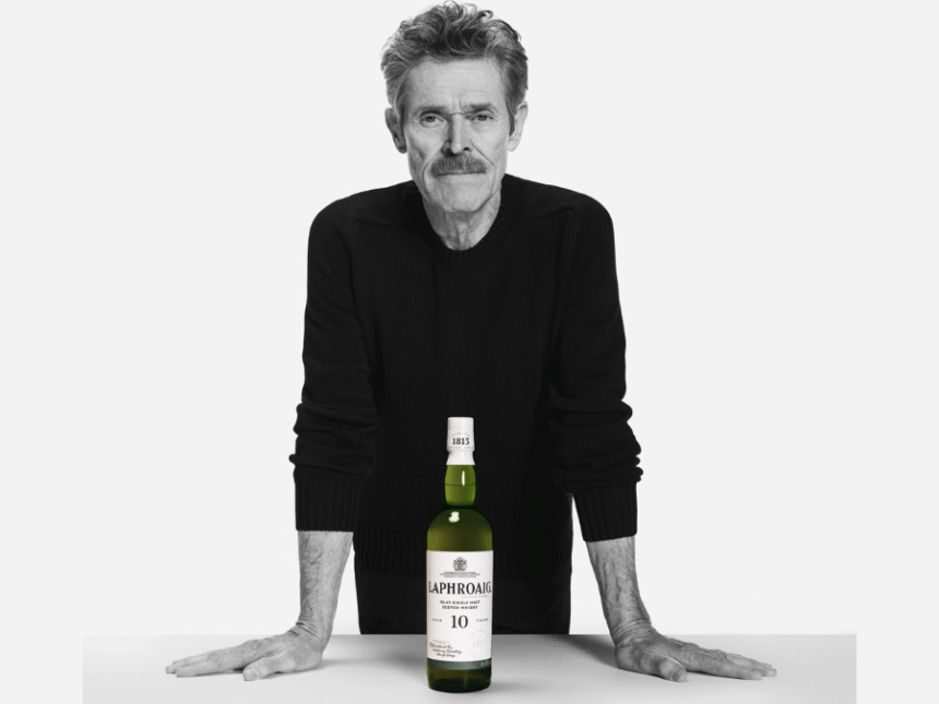 Willem Dafoe with a bottle of Laphroaig