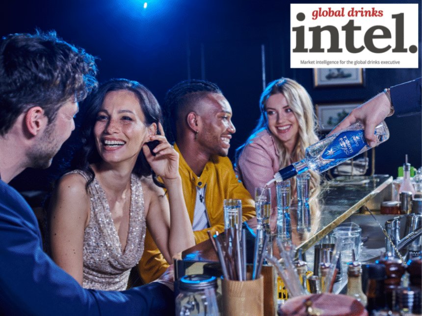 Consumers at a bar being served Antica sambuca
