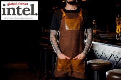 Bartender standing in front of a bar