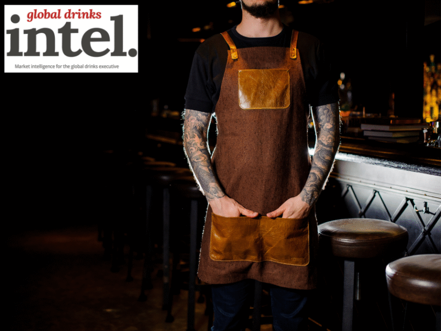 Bartender standing in front of a bar