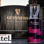The English Premier League trophy in front of a Guinness-branded gate