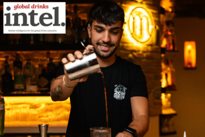 Bartender pouring a cocktail at a bar