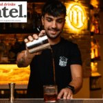 Bartender pouring a cocktail at a bar