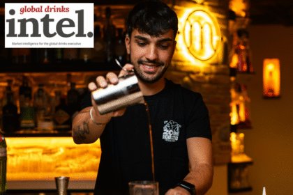 Bartender pouring a cocktail at a bar