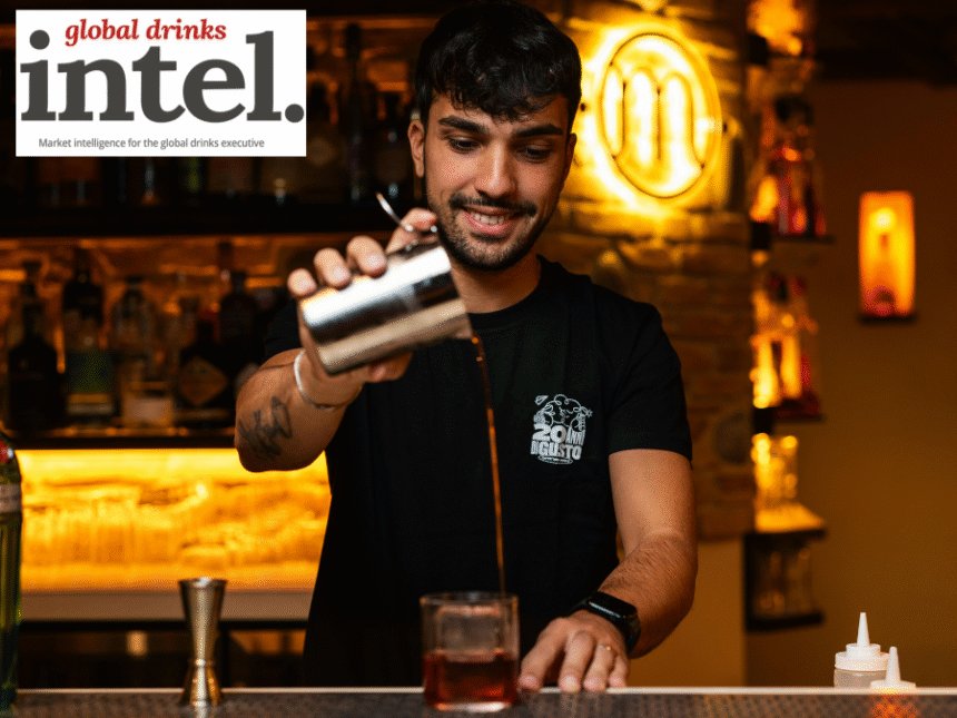 Bartender pouring a cocktail at a bar