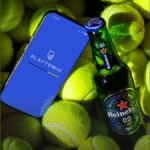 Playtomic on phone with Heineken 0.0 bottle