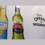 Non-alc Corona and Stella Artois bottles on wall