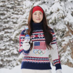 Olympic gold medalist Chloe Kim stands in a snowy scene holding a beer