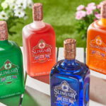 Four bottles of Slingsby Gin on a table in sunshine