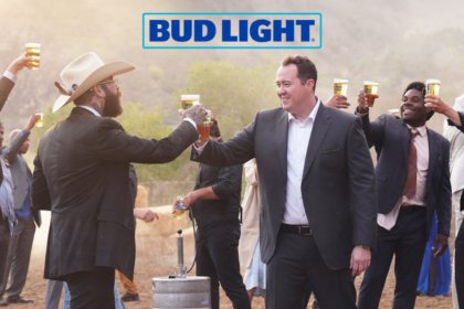 Two white men cheers a Bud Light beer at a wedding