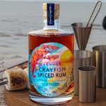 Bottle of rum on a table outside with barbecue accessories