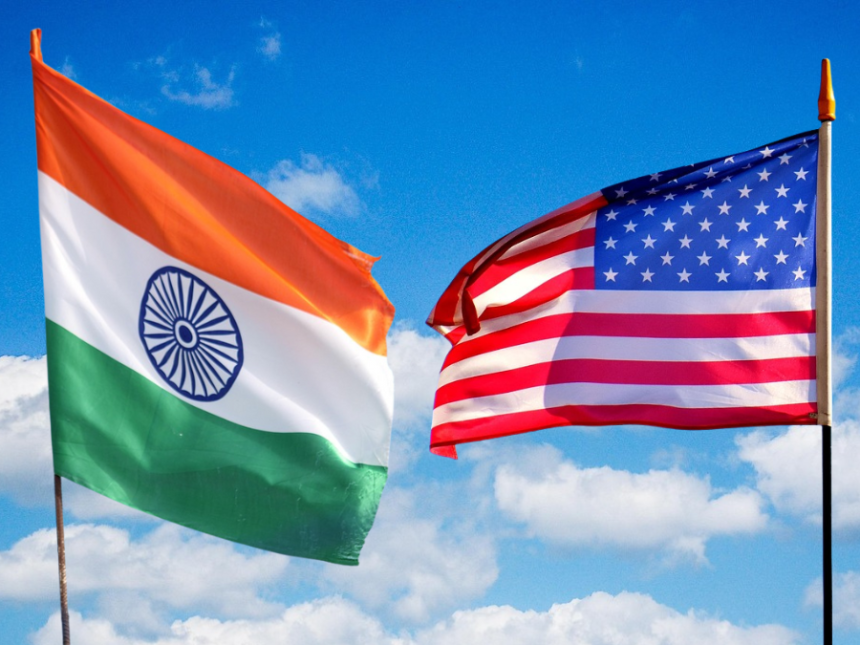 India and US flags against sky