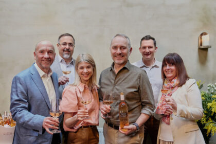 Members of Viña Concha y Toro and Maison Mirabeau stand smiling with glasses of wine