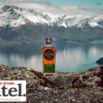 Scapegrace whisky bottle against lake and mountain backdrop