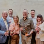 Members of Viña Concha y Toro and Maison Mirabeau stand smiling with glasses of wine
