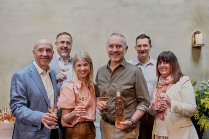 Members of Viña Concha y Toro and Maison Mirabeau stand smiling with glasses of wine