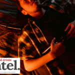 Drunk male consumer lying back with empty bottles
