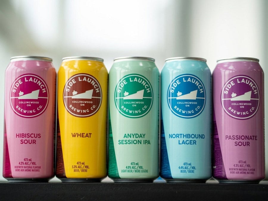Line up of Side Launch Brewing Co cans