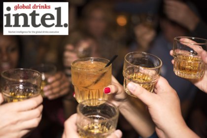 Four raised glasses in a crowd