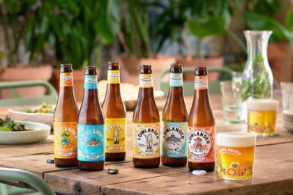 Bottles of Lowlander LoNo beers on a wooden table outside